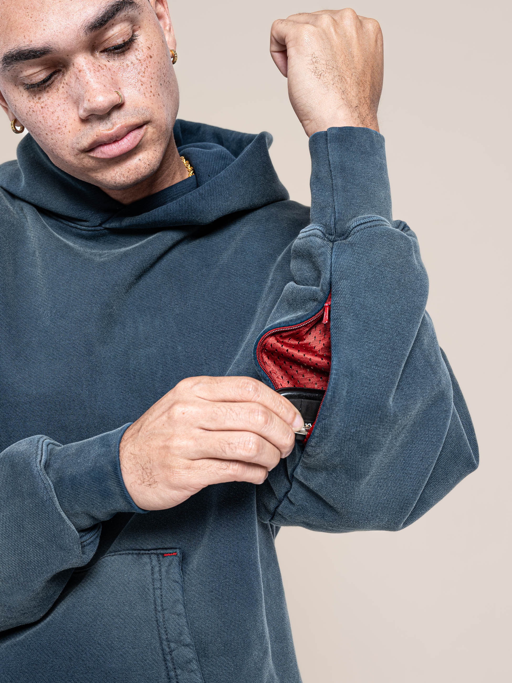 male model puts his key inside of the hidden pocket at the left arm