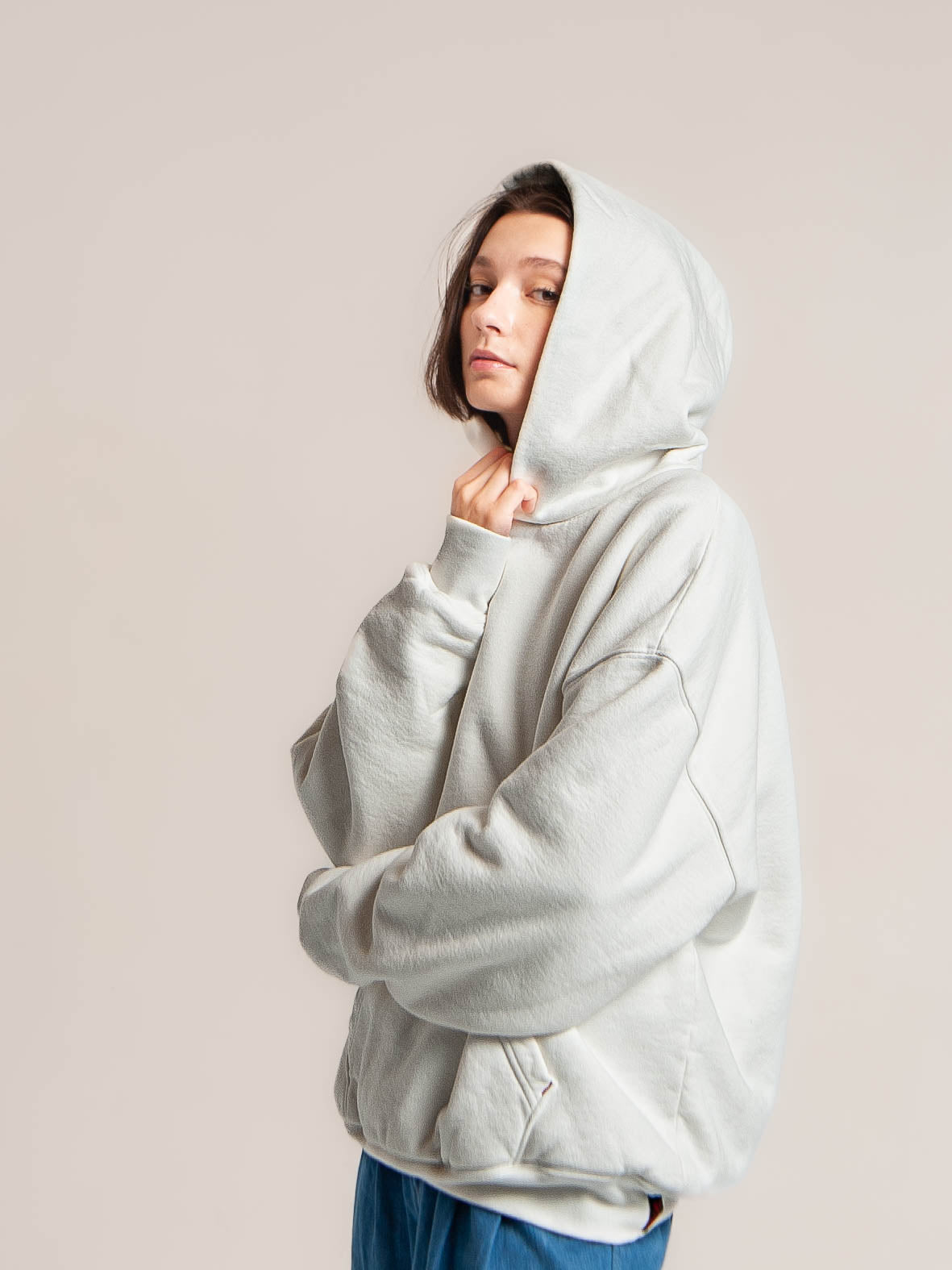 Female model wears Publik Brand Double Layered Hoodie Acoustic White Heavyweight Fleece, all made in USA