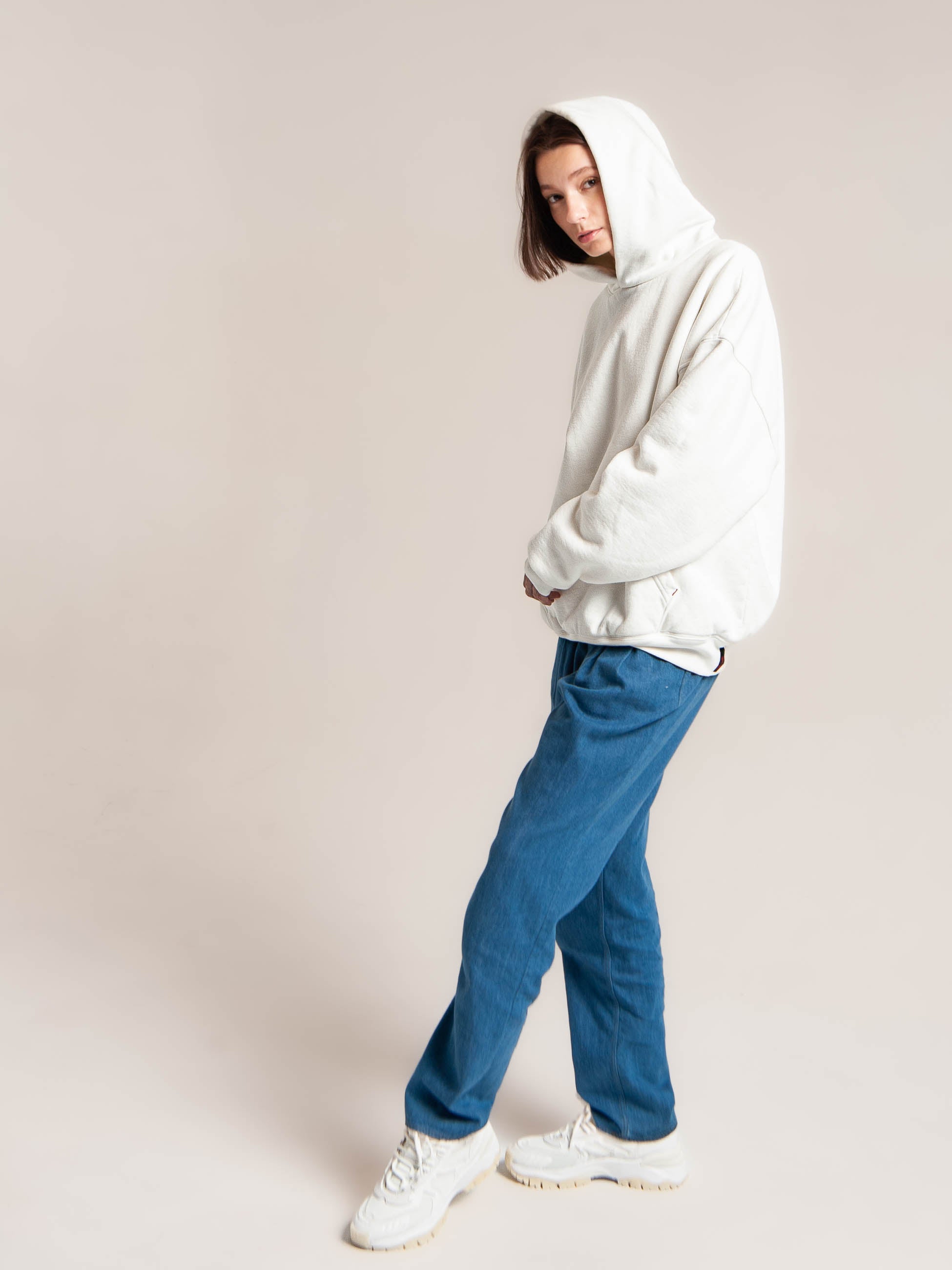 Female model wears Publik Brand Double Layered Hoodie Acoustic White Side view Heavyweight Fleece, all made in USA