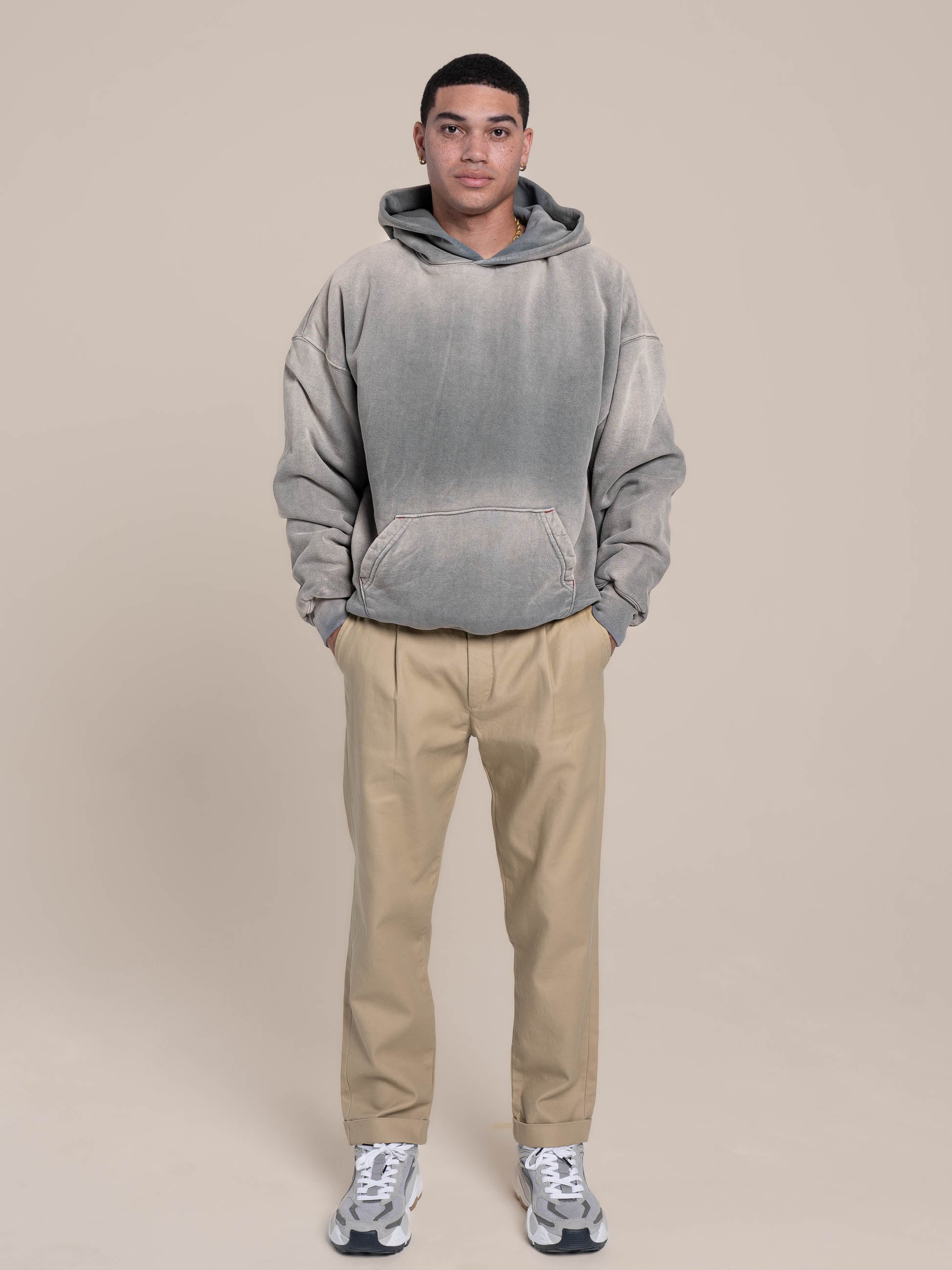 Male Model wears ash blue hoodie with khaki pants
