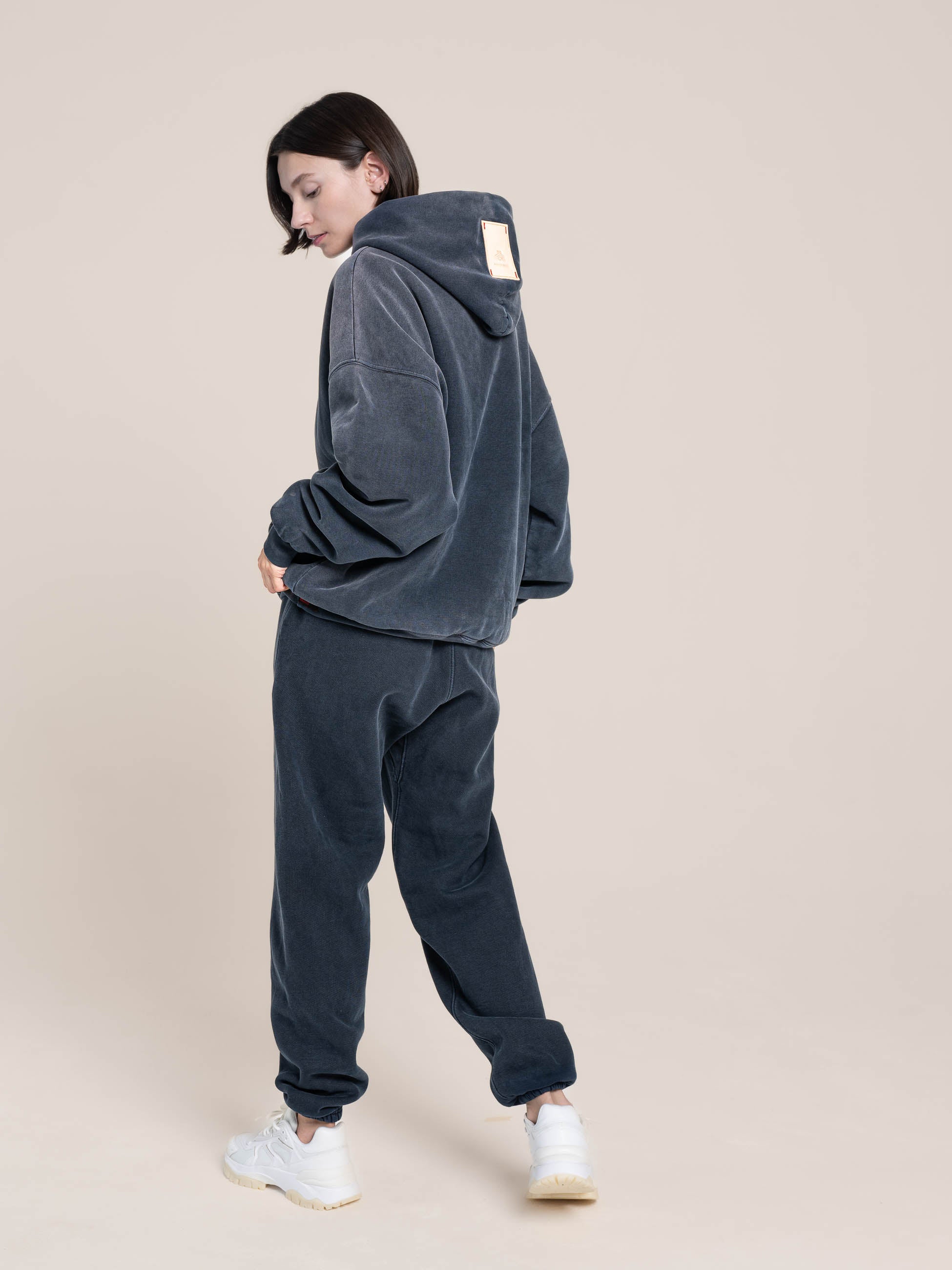 female model shows back of the double layered hoodie and fleece sweatpants college navy Made in USA