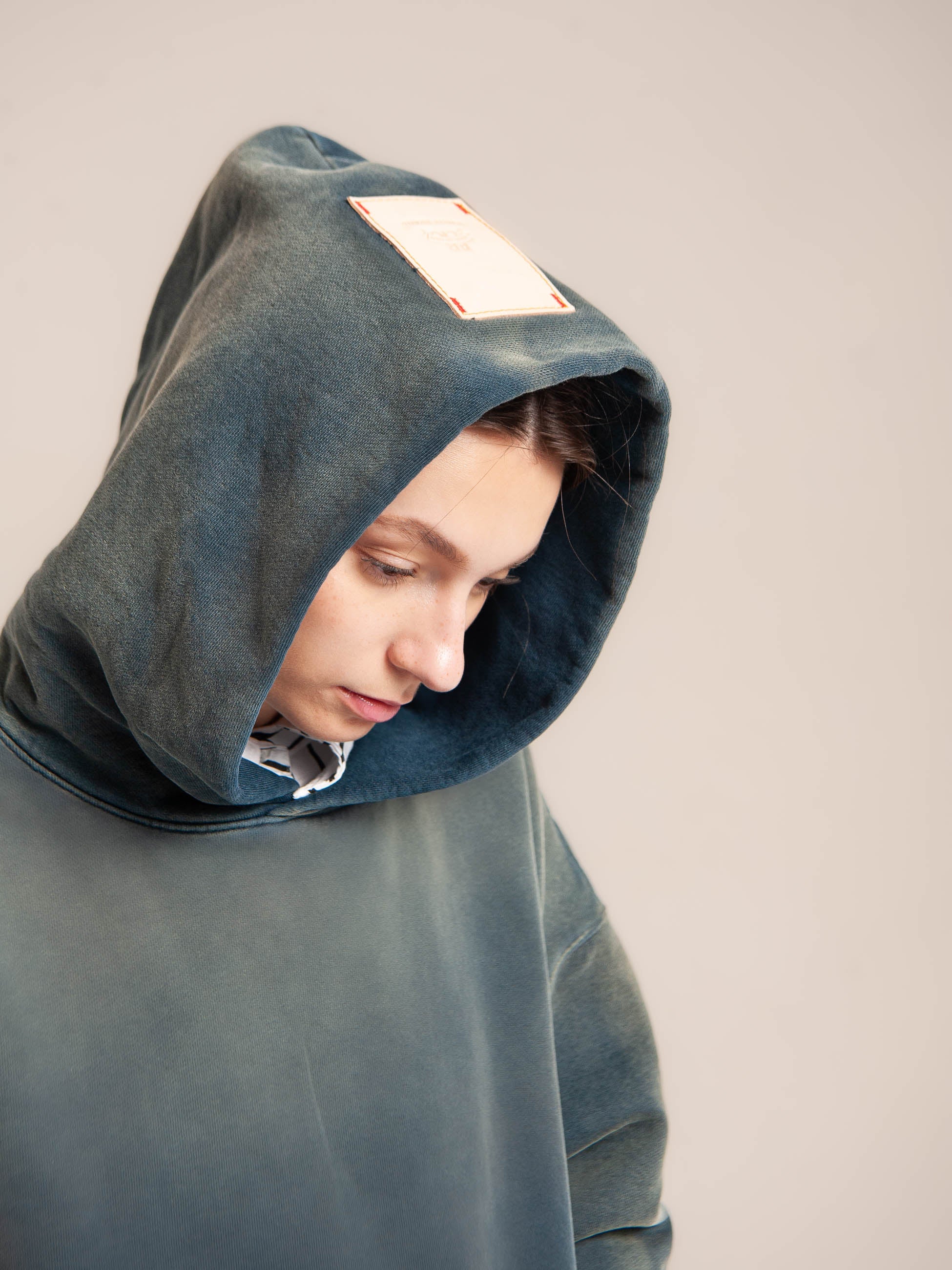 Female model wears Publik Brand Double Layered Fleece Indigo Hoodie