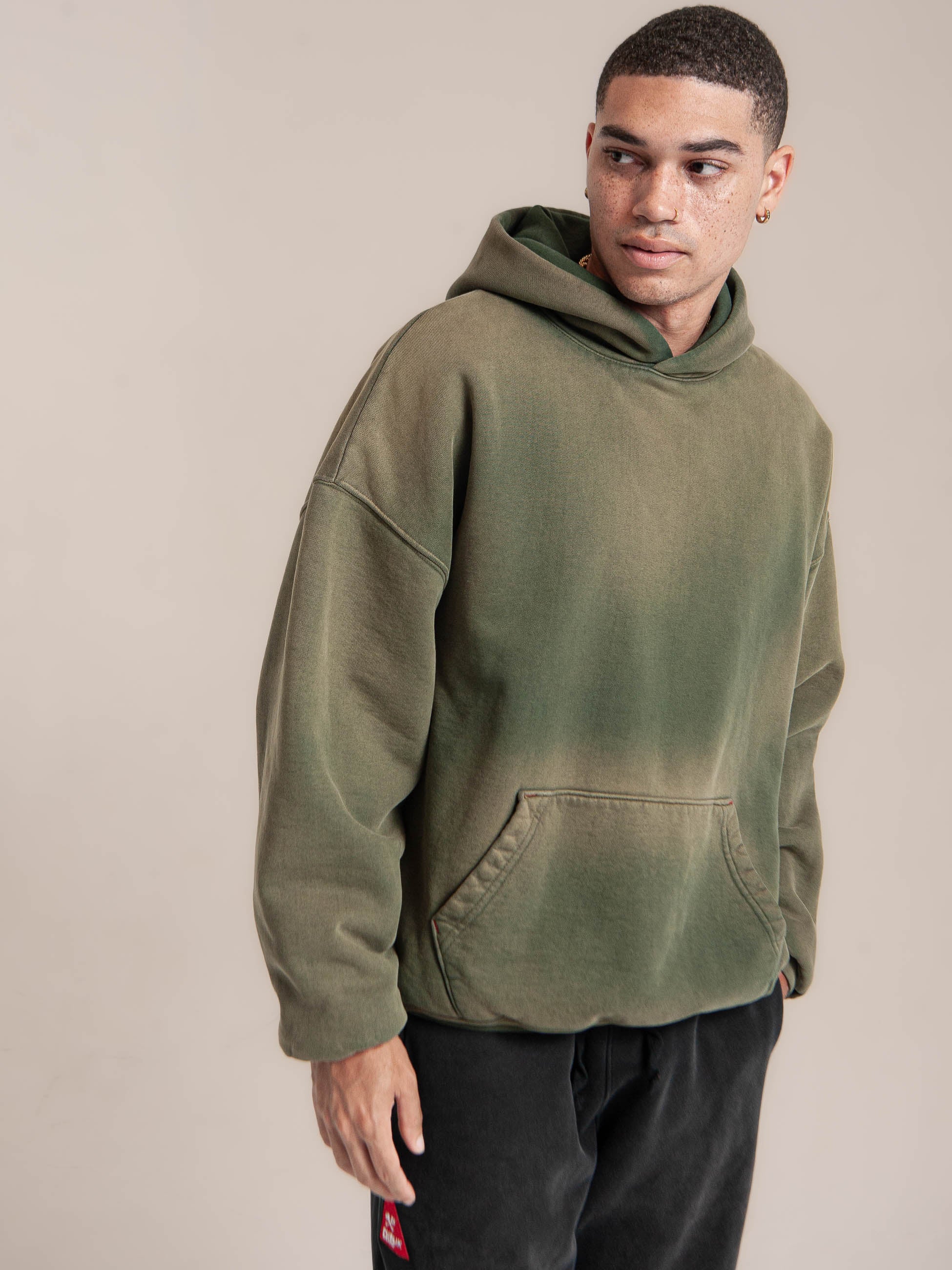 Male Model wears Publik Brand Double Layered Hoodie Reseda Green Heavyweight Fleece, all made in USA