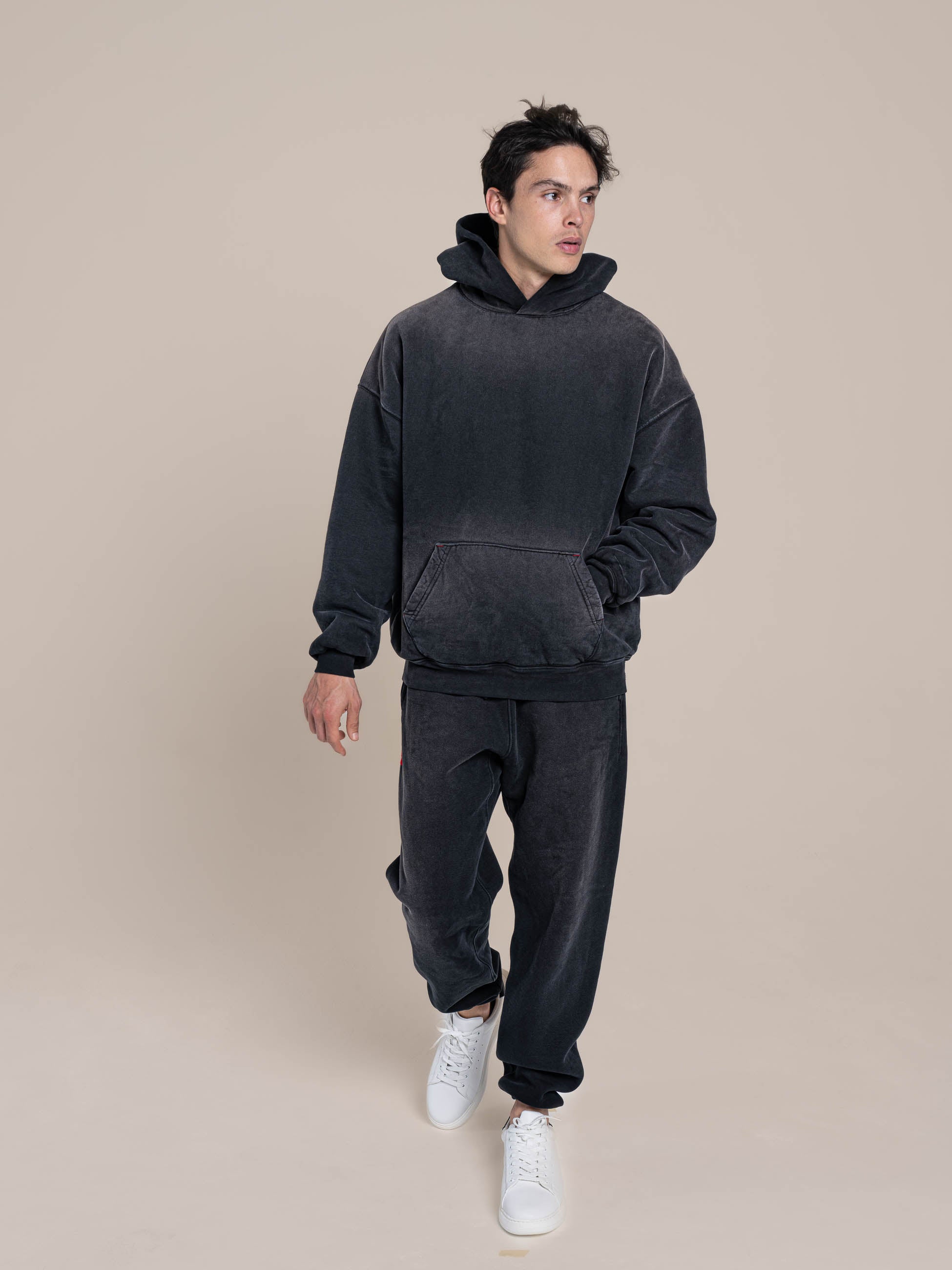 Male Model with Double Layered Black Hoodie and Fleece Black Sweatpants Double Layered Fleece Black Hoodie Flat Luxury Made in USA