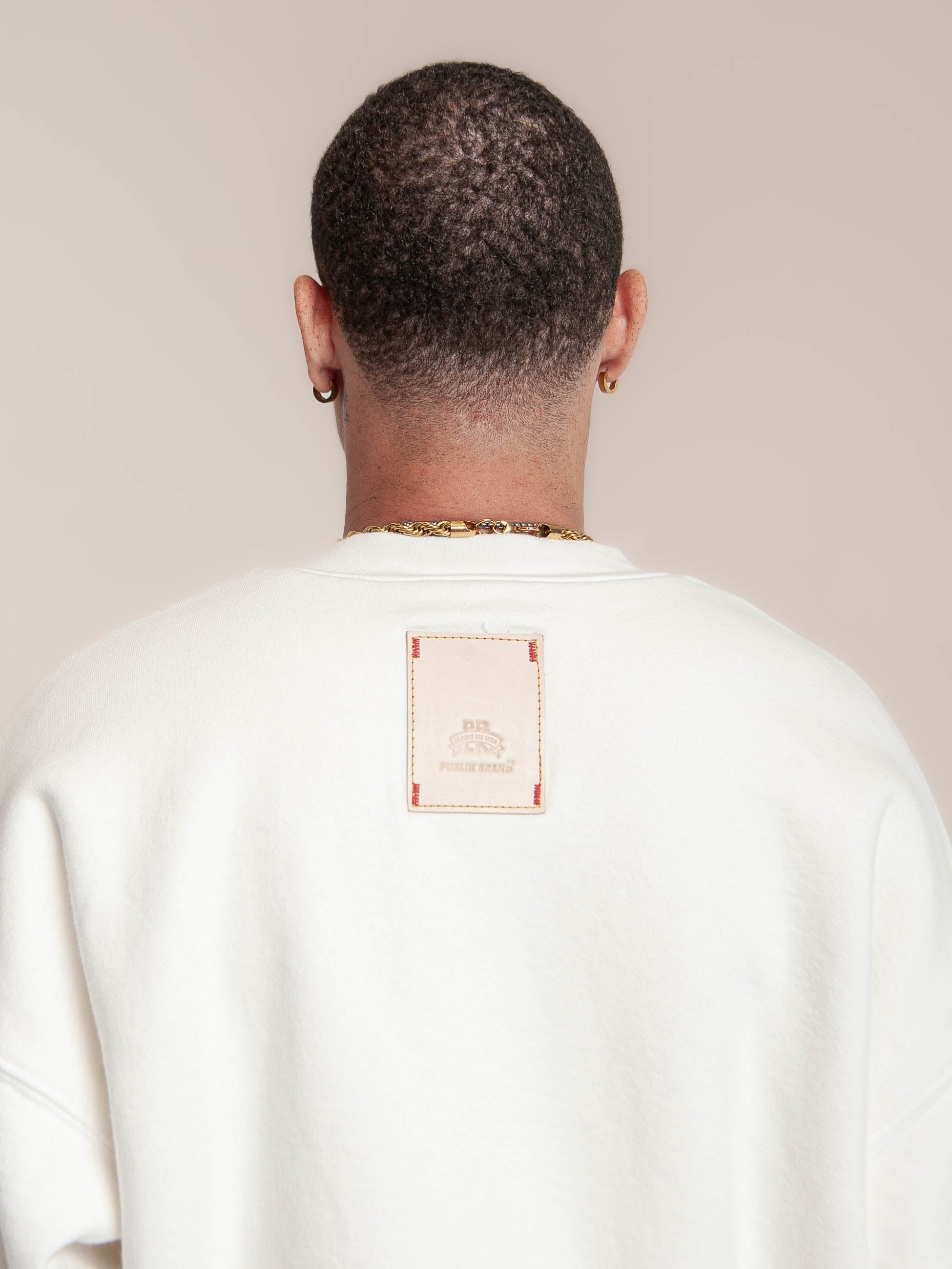 male model wears Publik Brand Double Layered Sweatshirt Crewneck Acoustic White Heavyweight Fleece, all made in USA, back side detail