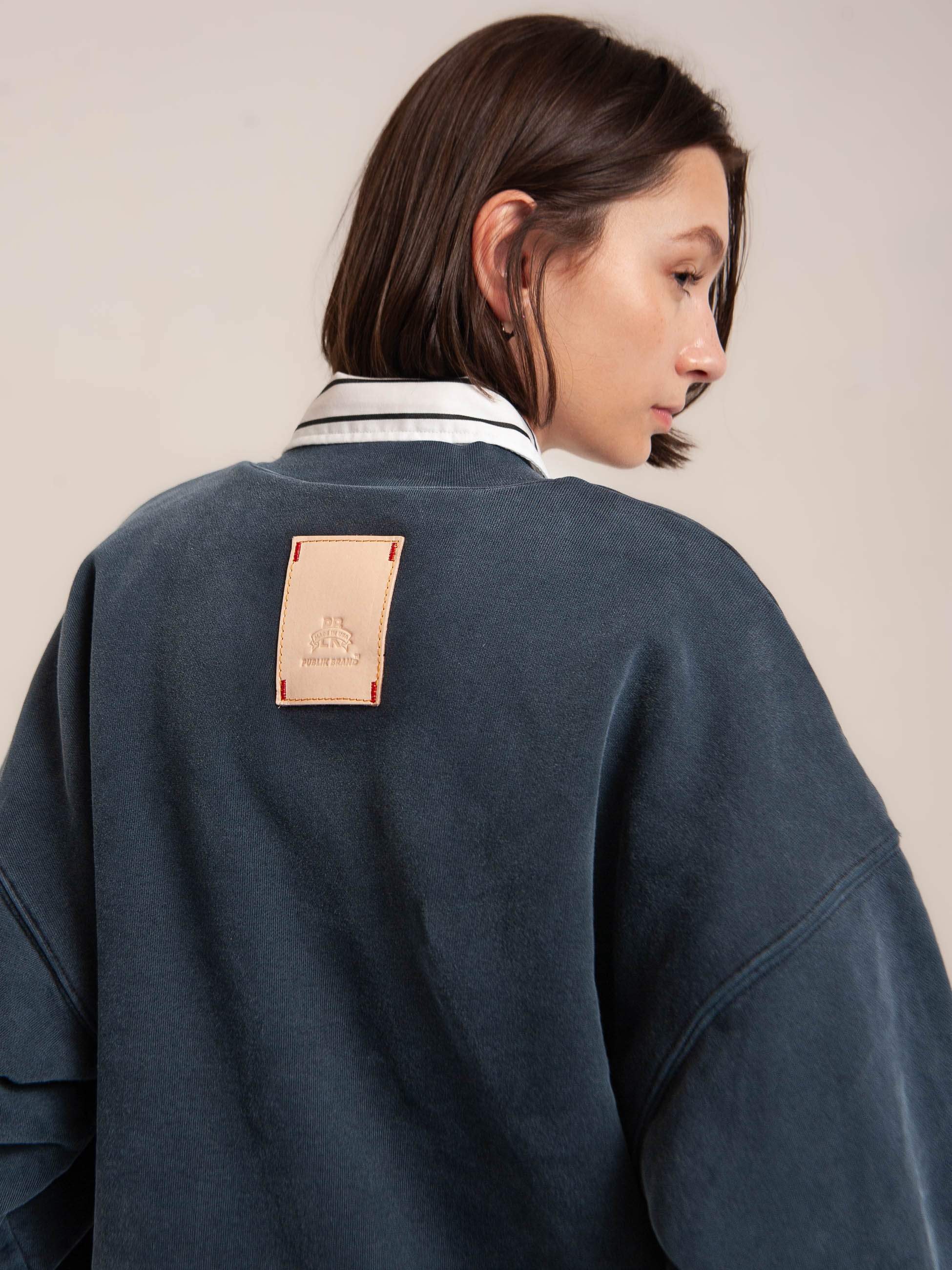 female model wears Publik Brand Double Layered Sweatshirt Crewneck College Navy Heavyweight Fleece, all made in USA, back side view