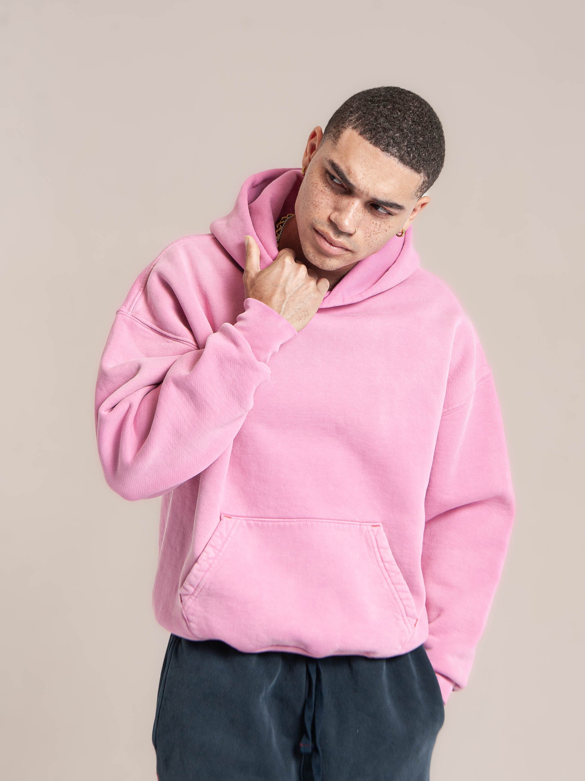 male model wears Publik Brand Single Layered Hoodie Hollywood Cerise Pink Heavyweight Fleece, all made in USA