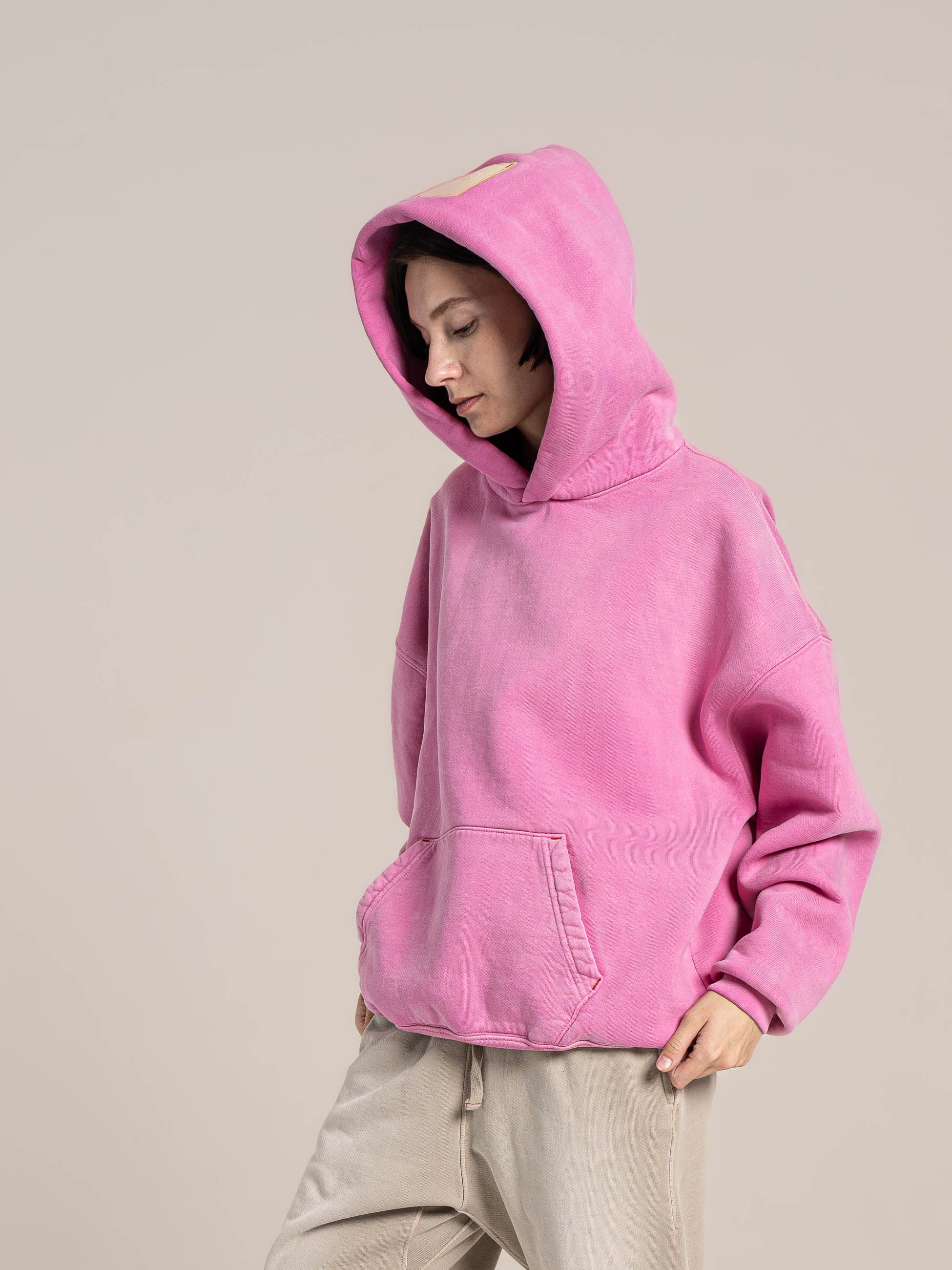 female model wears Publik Brand Single Layered Hoodie Hollywood Cerise Pink Heavyweight Fleece, all made in USA