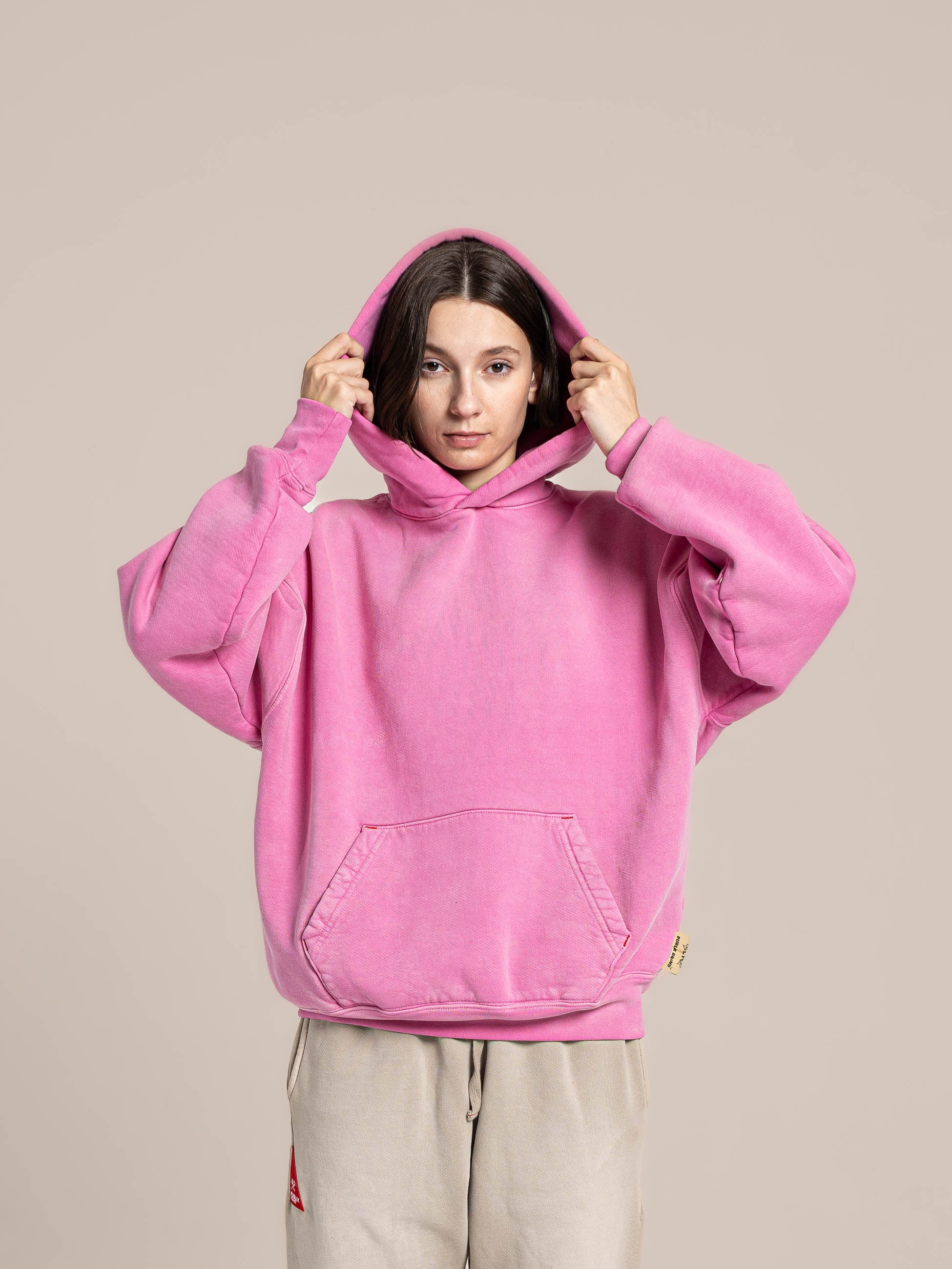 female model wears Publik Brand Single Layered Hoodie Hollywood Cerise Pink Heavyweight Fleece, all made in USA