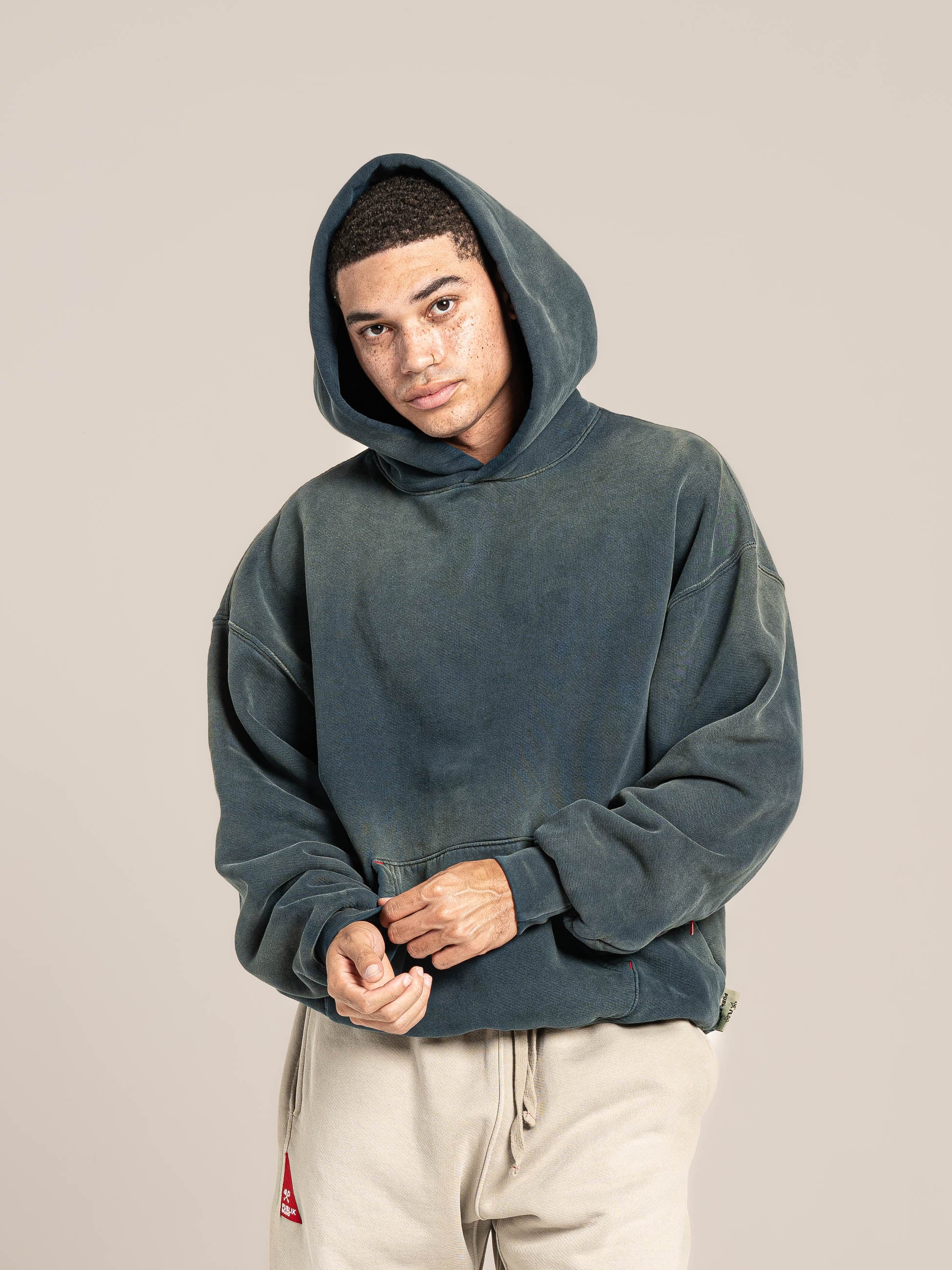 Male Model wears Publik Brand Single Layered Hoodie Indigo Heavyweight Fleece, all made in USA