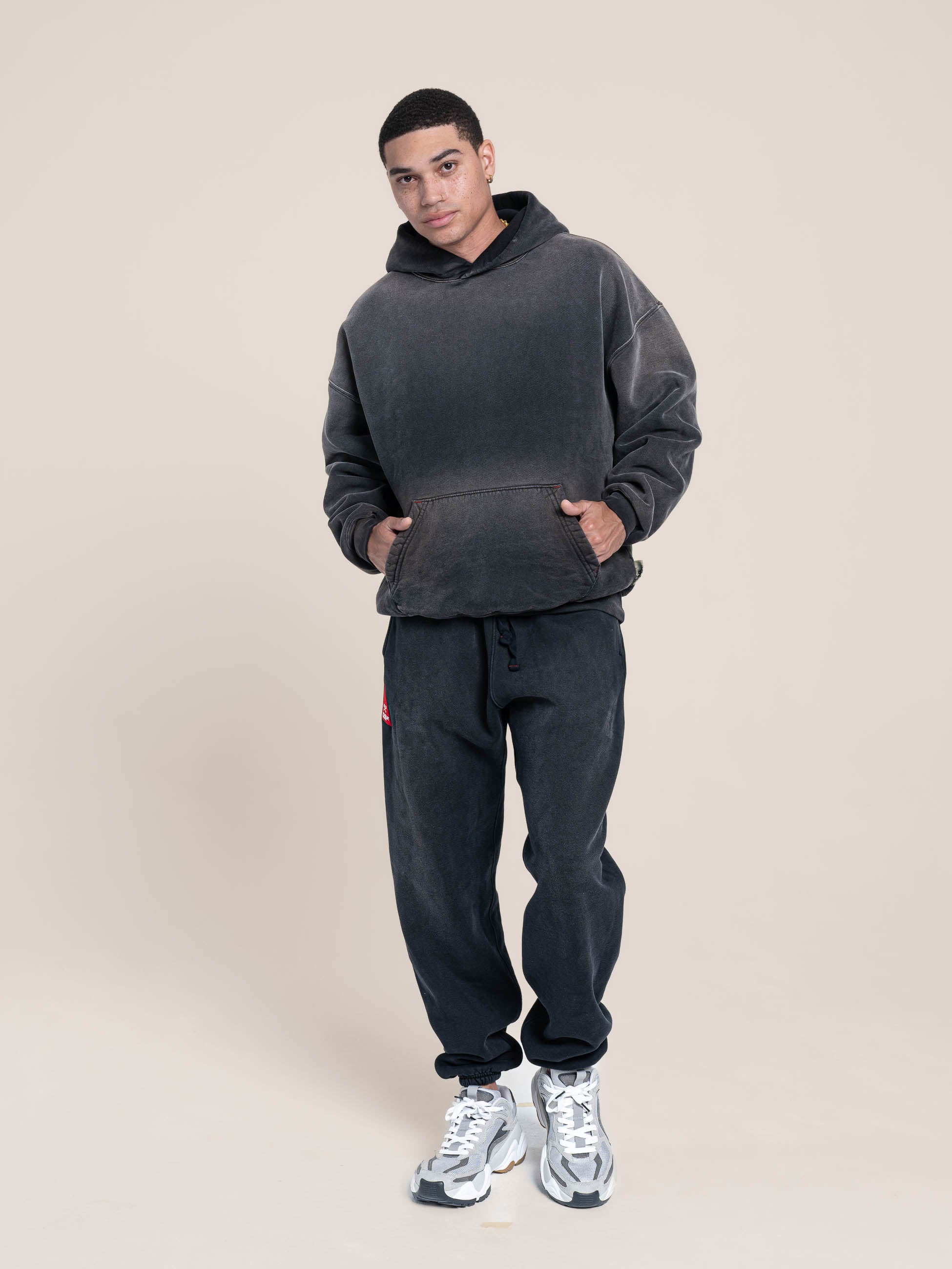 male model wears Publik Brand Single Layered Hoodie Yacht Club Black Heavyweight Fleece, all made in USA