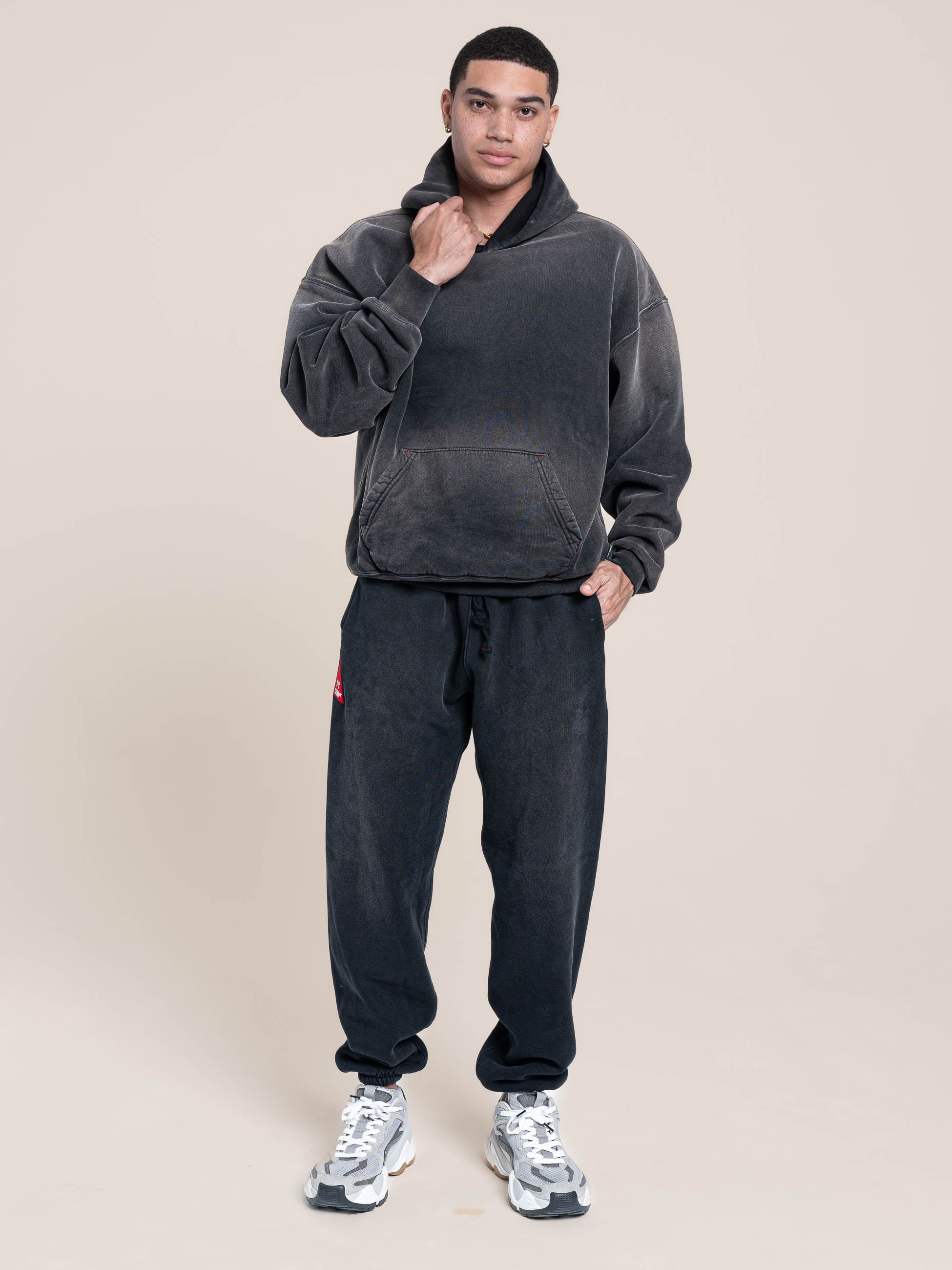 Male Model wears Publik Brand Single Layered Hoodie Yacht Club Black Heavyweight Fleece, all made in USA